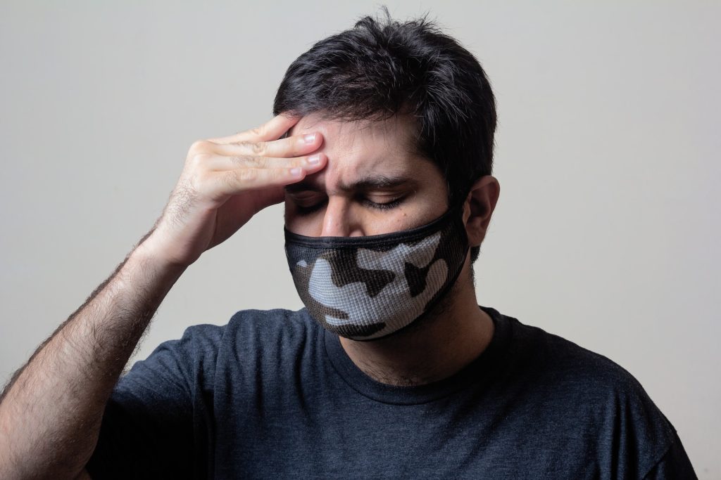 Man wearing mask with headache