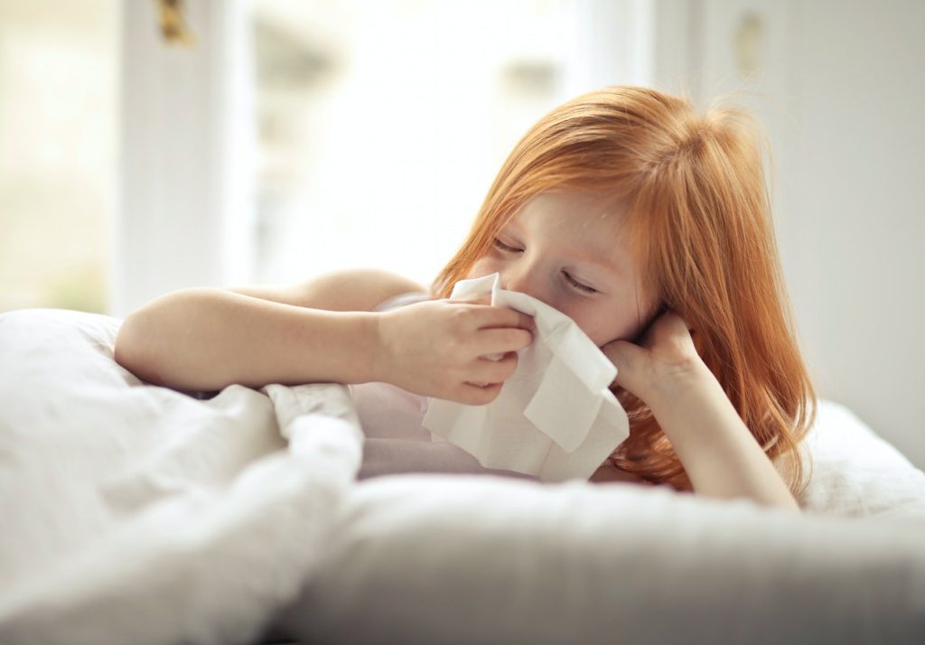 Young girl sneezing