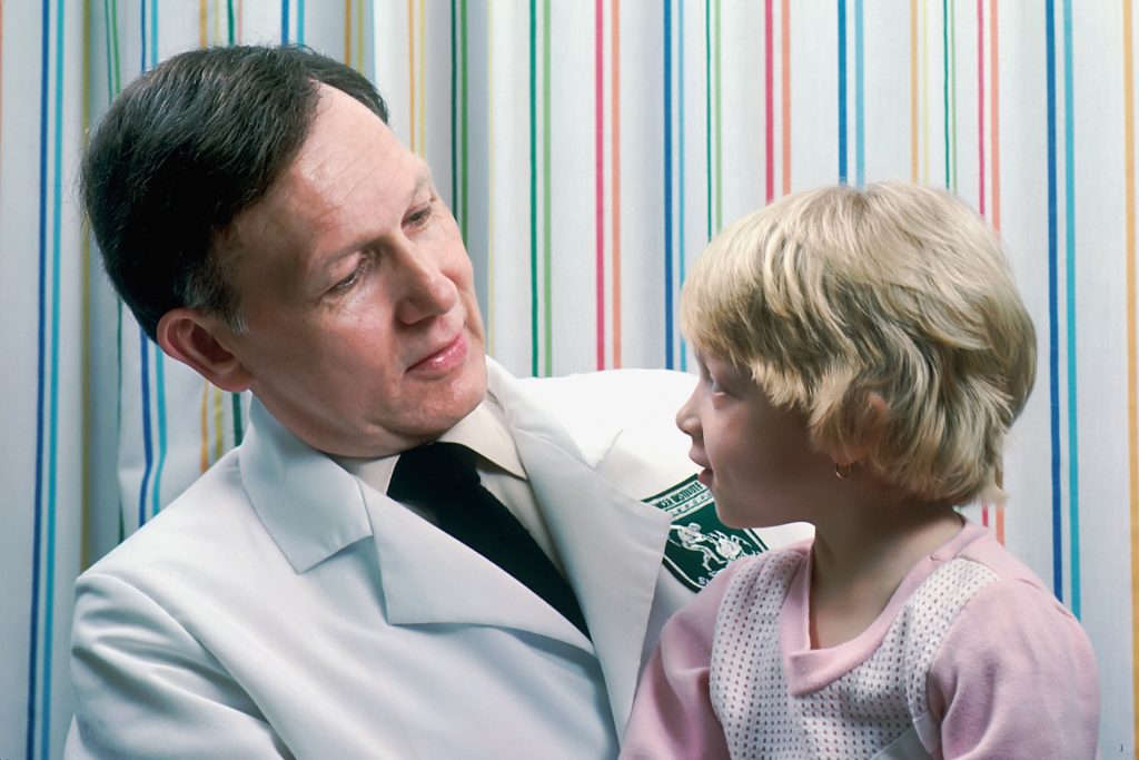 Male doctor with young girl patient