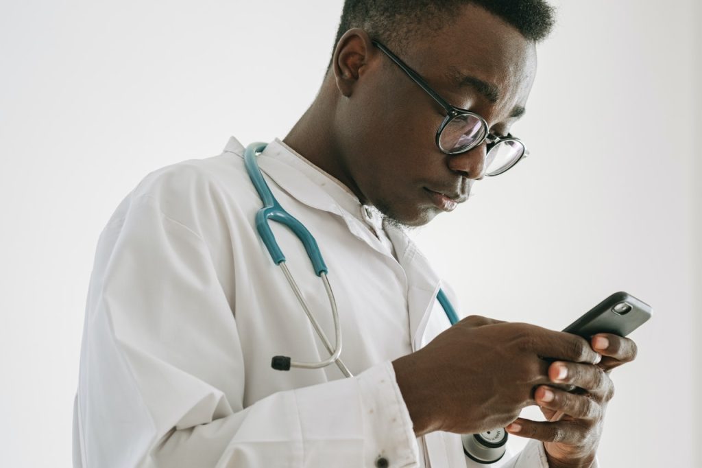 Male doctor with smartphone